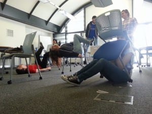 An image of the the actors at work showing how their relationship with chairs - which will be a motif in our piece- is challenged and changed to reflect thoughts on adulthood.10403407_877722225583476_4836400386376306855_n
